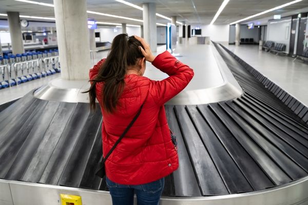 Woman at airport luggage belt